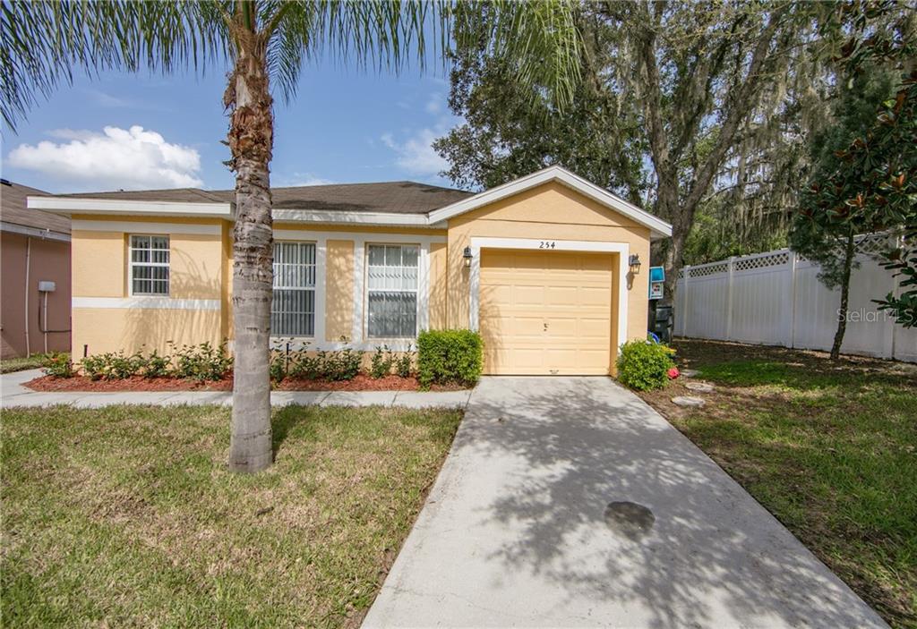 254 Ridgemont Court Davenport, FL 33896 - Photo 1 of 1 a front view of a house with a yard and garage