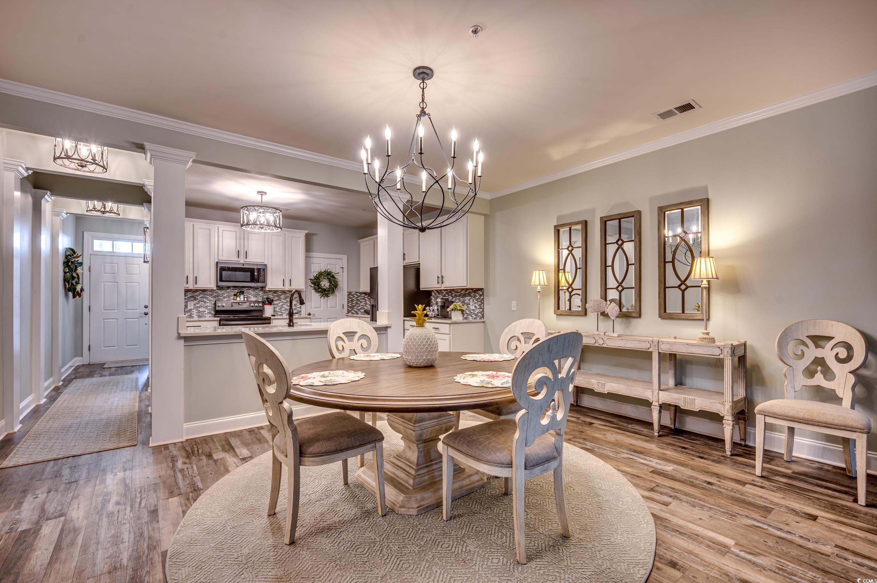 701 Pickering Drive, Unit 203 Murrells Inlet, SC 29576 - Photo 12 of 35 LVP floors and impressive chandelier