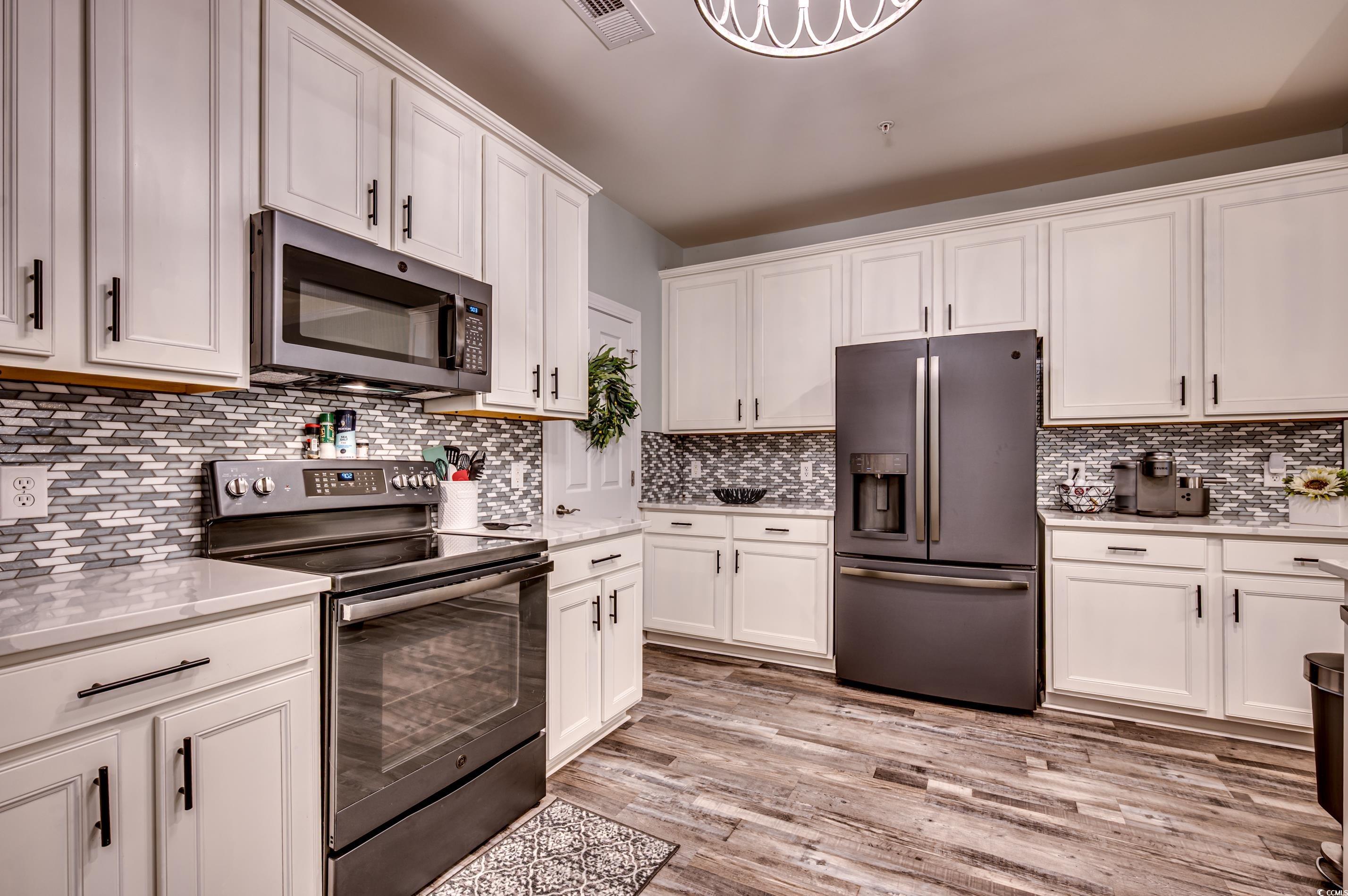 701 Pickering Drive, Unit 203 Murrells Inlet, SC 29576 - Photo 13 of 35 White cabinetry and quartz countertops