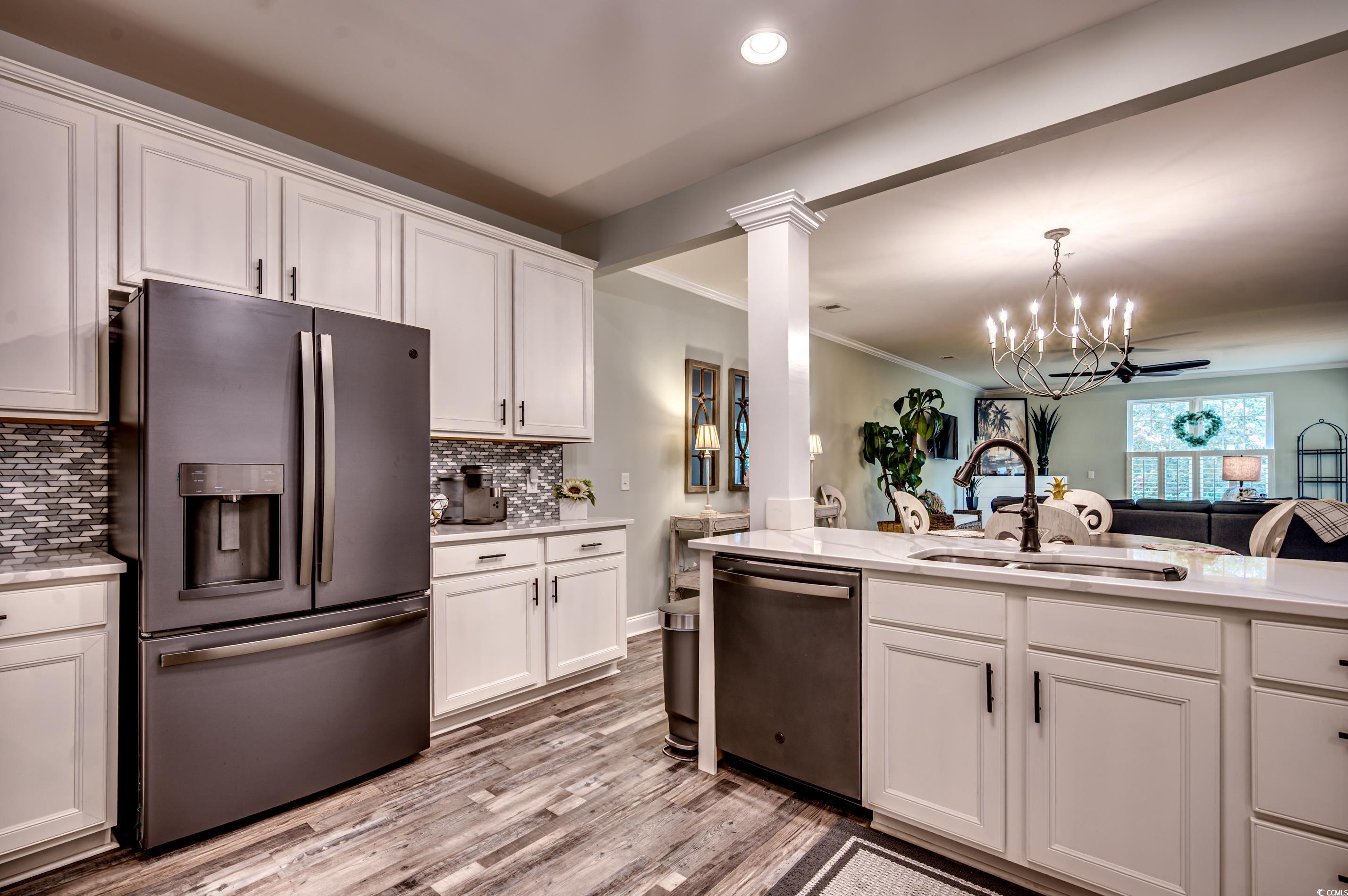 701 Pickering Drive, Unit 203 Murrells Inlet, SC 29576 - Photo 14 of 35 Cabinets with crown, tile backsplash, slate appliances
