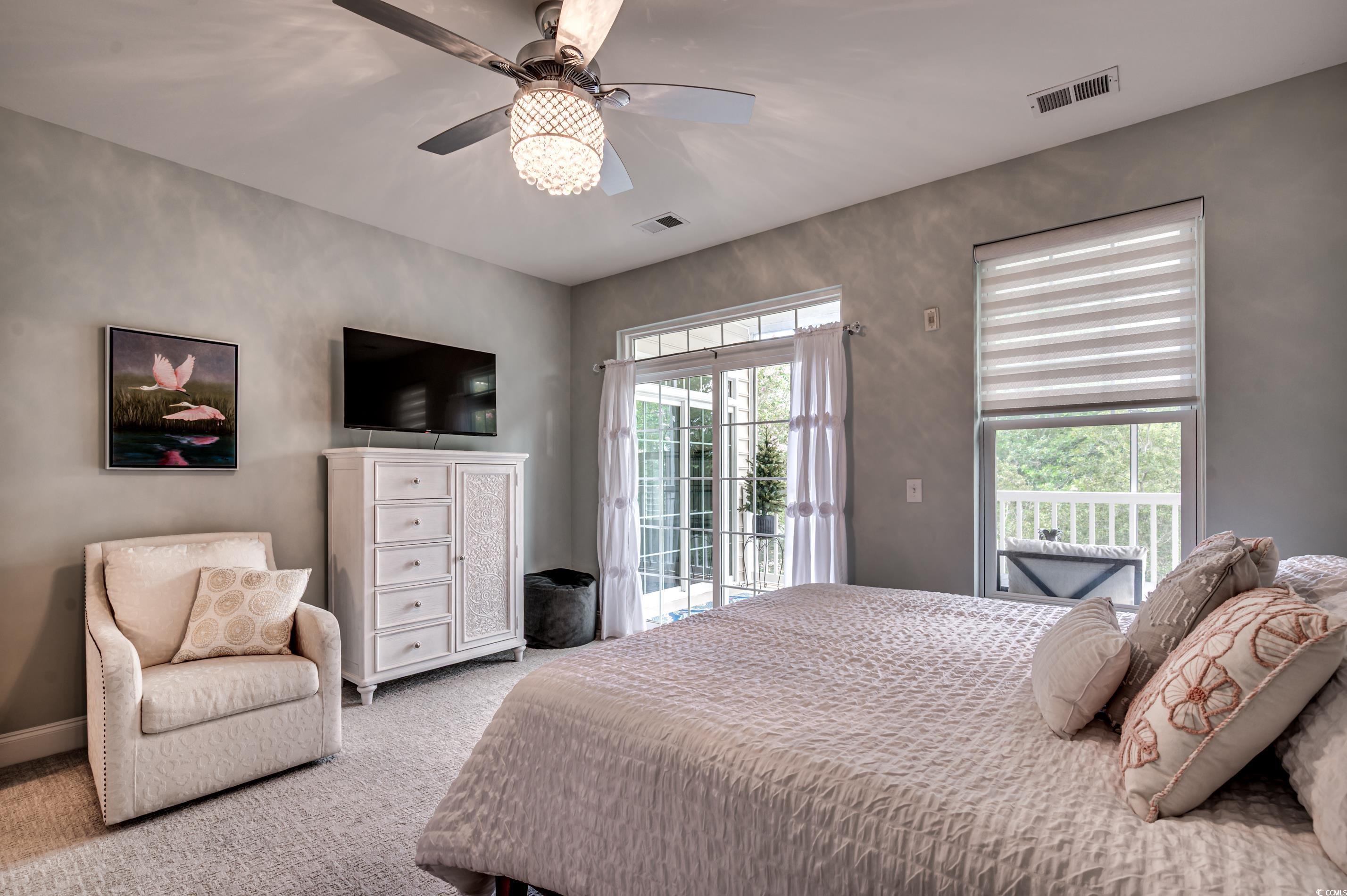 701 Pickering Drive, Unit 203 Murrells Inlet, SC 29576 - Photo 18 of 35 Carpeted bedroom with access to screened porch and a decorative ceiling fan