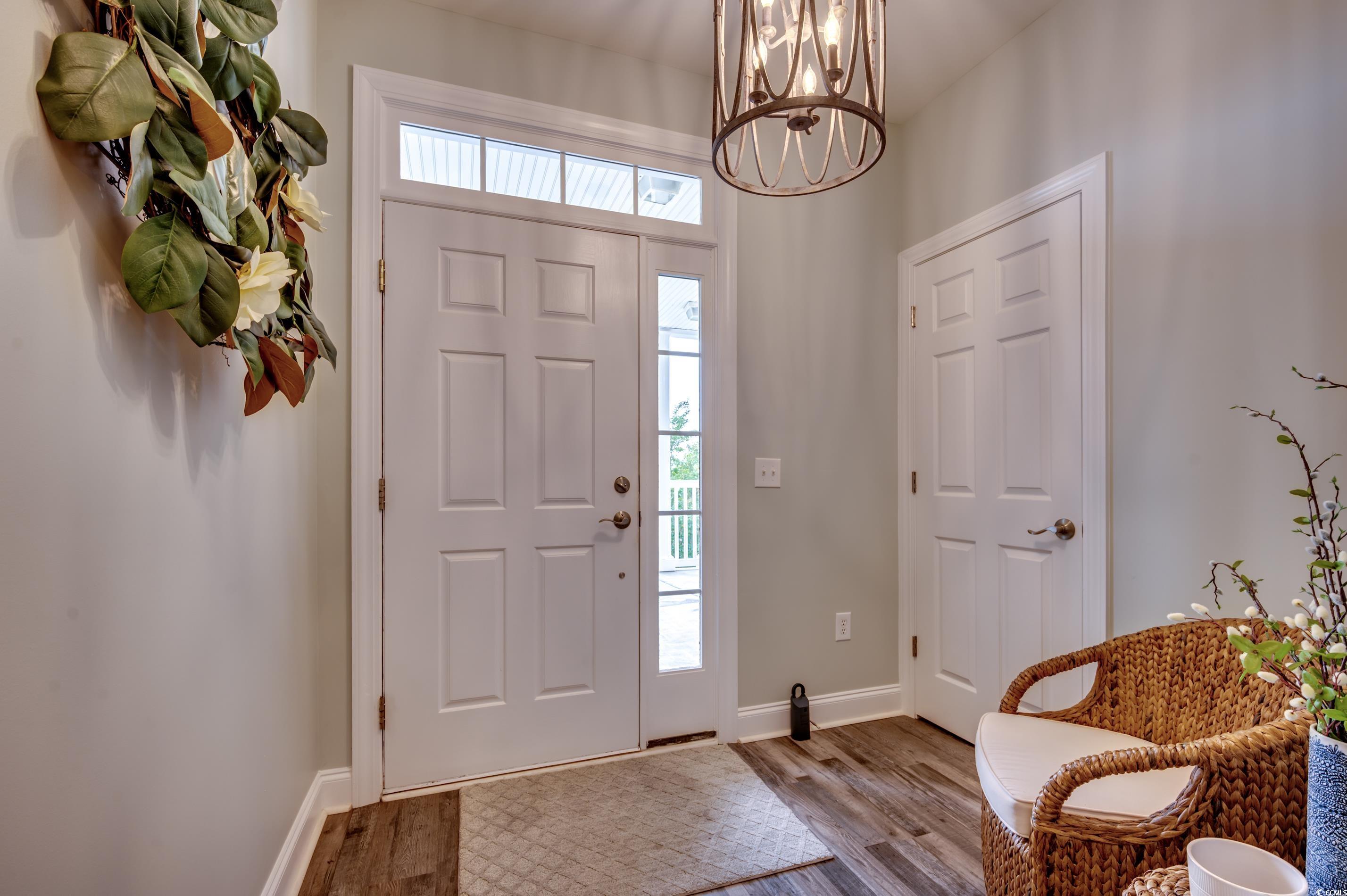 701 Pickering Drive, Unit 203 Murrells Inlet, SC 29576 - Photo 4 of 35 Foyer entrance with plenty of natural light, LVP flooring and elegant chandelier