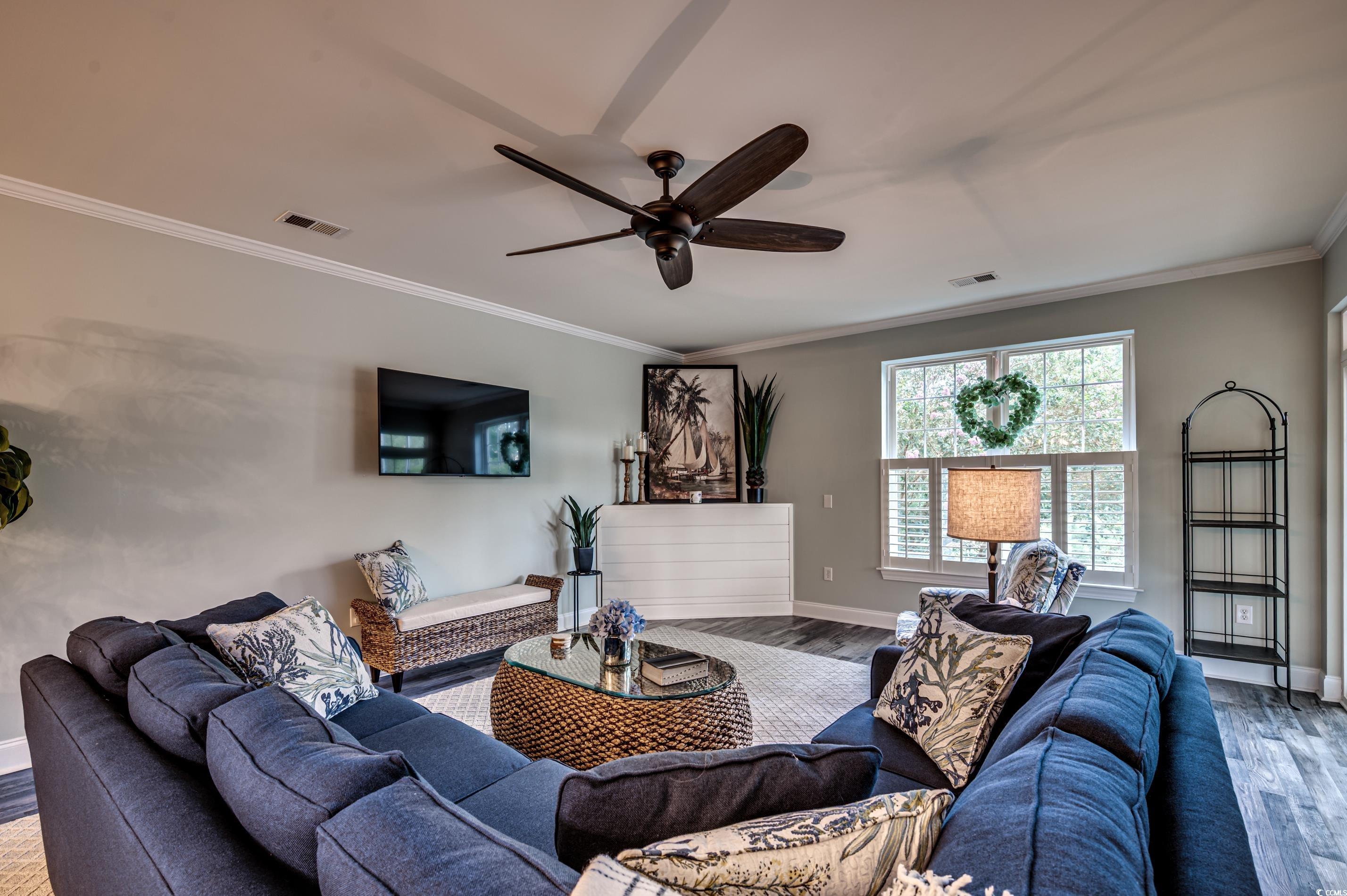 701 Pickering Drive, Unit 203 Murrells Inlet, SC 29576 - Photo 7 of 35 LVP flooring and ceiling fan. Crown molding and mounted TV which conveys