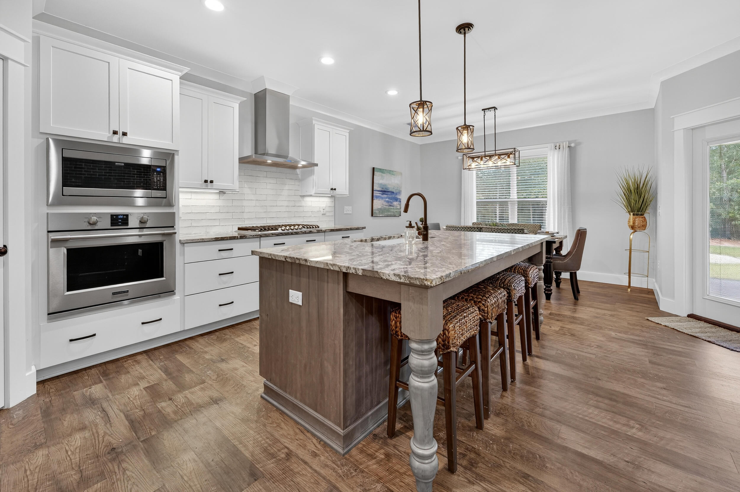 768 Long Road DeFuniak Springs, FL 32433 - Photo 17 of 106 a kitchen with stainless steel appliances granite countertop a kitchen island hardwood floor sink and stove