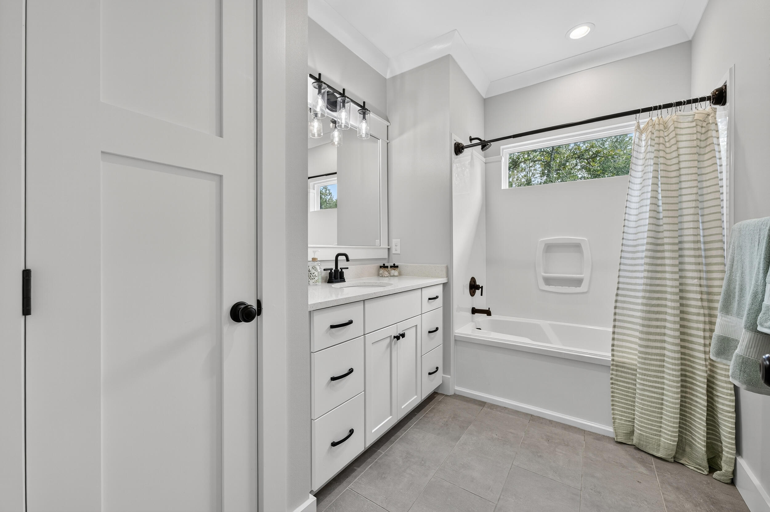 768 Long Road DeFuniak Springs, FL 32433 - Photo 48 of 106 a bathroom with a double vanity sink a mirror a bathtub and shower