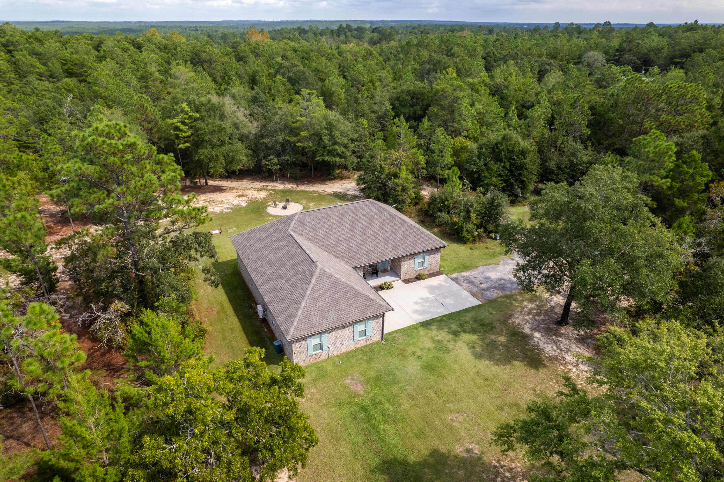 768 Long Road DeFuniak Springs, FL 32433 - Photo 97 of 106 a view of a yard with a swimming pool and outdoor seating
