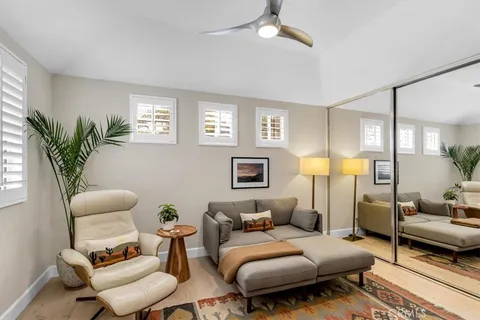 a bedroom with furniture and a chair