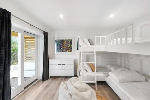 a bedroom with a bed table and a window