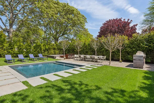 a view of a house with a yard and sitting area