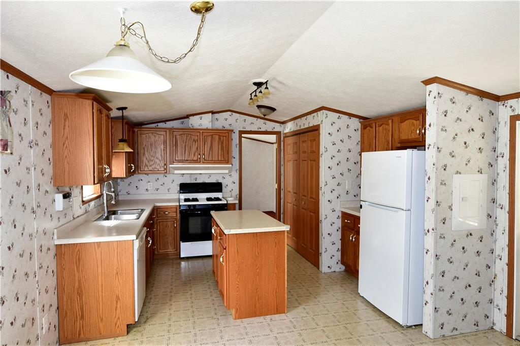 604 Deana Way Rochester, PA 15074 - Photo 14 of 22 a kitchen with granite countertop a refrigerator a stove top oven a sink and dishwasher