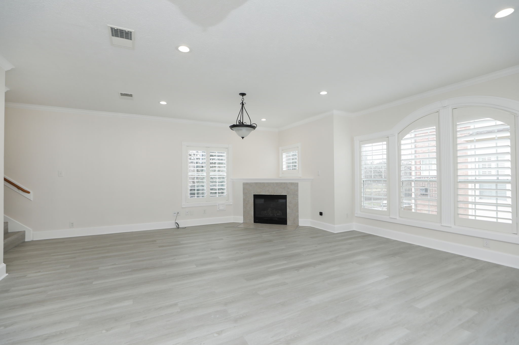 1893 Ewing Street Houston, TX 77004 - Photo 13 of 39 an empty room with windows and fireplace