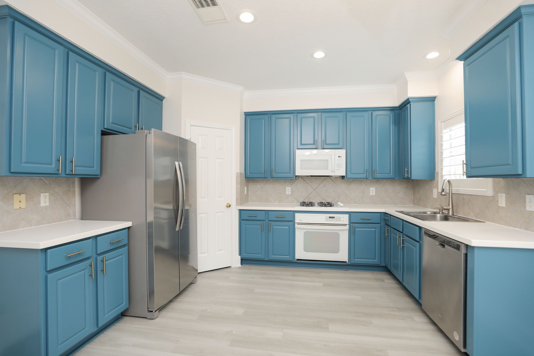1893 Ewing Street Houston, TX 77004 - Photo 18 of 39 a kitchen with stainless steel appliances granite countertop a refrigerator sink and cabinets