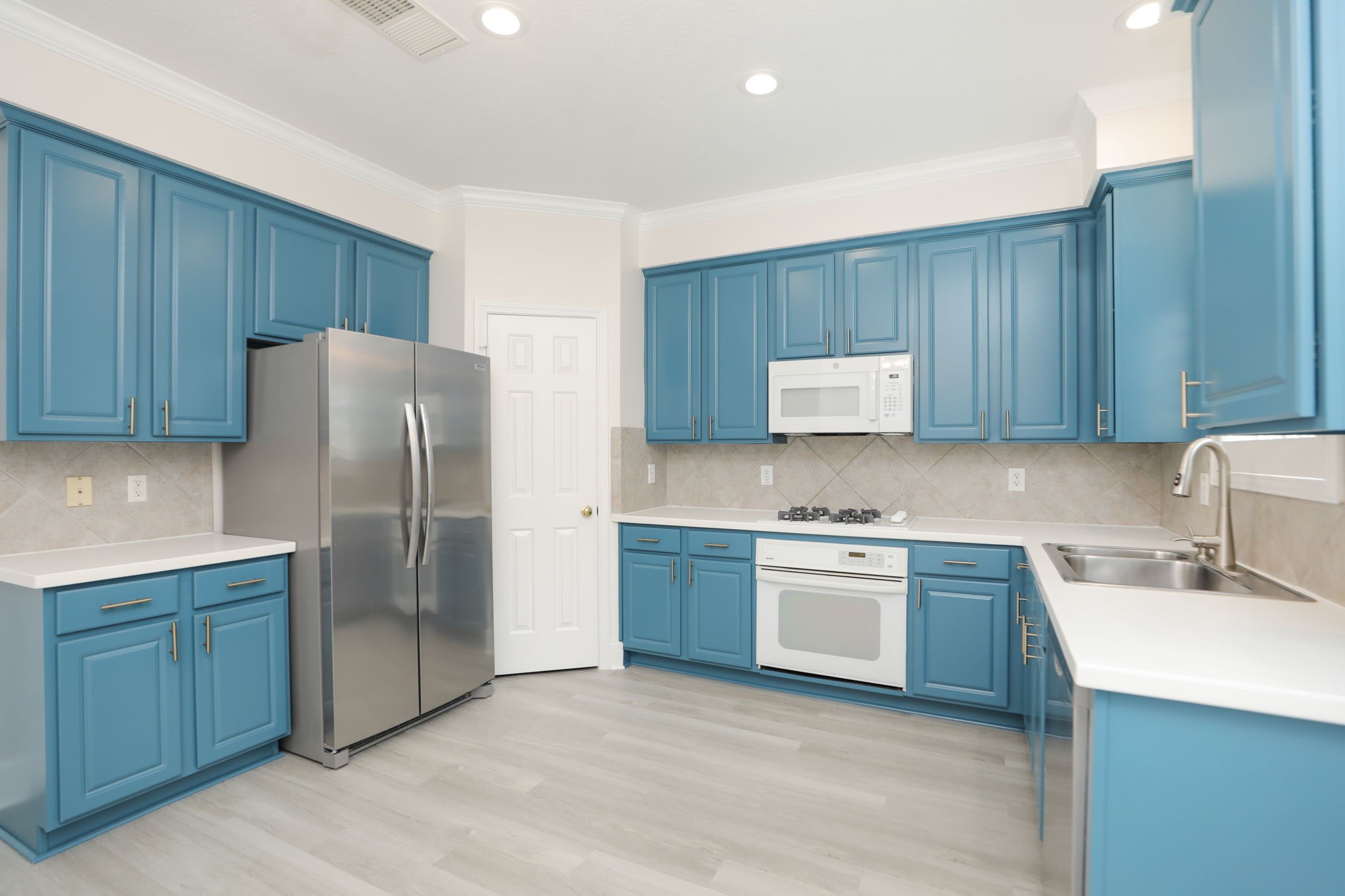1893 Ewing Street Houston, TX 77004 - Photo 19 of 39 a kitchen with stainless steel appliances granite countertop a refrigerator and a stove top oven
