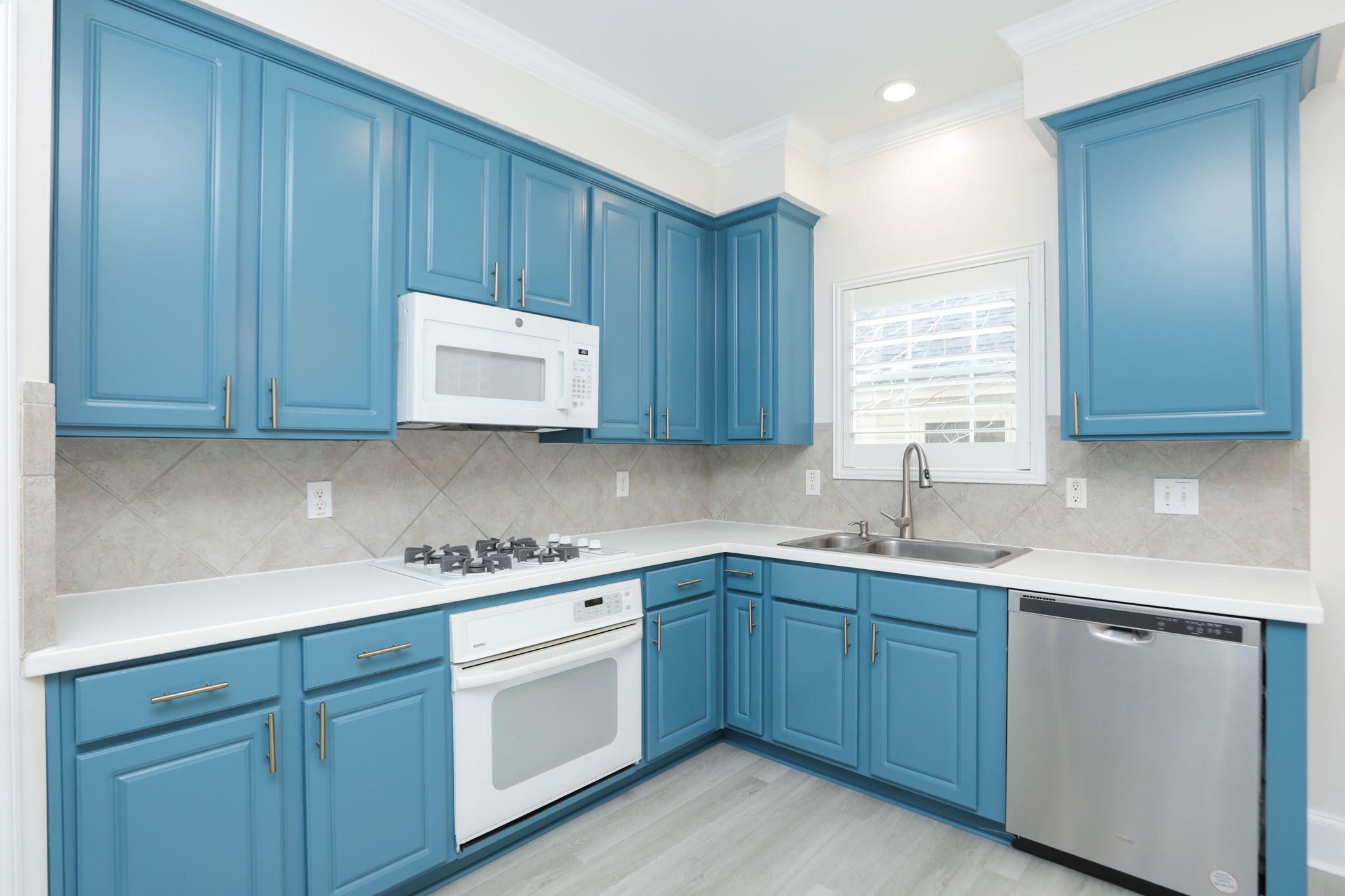 1893 Ewing Street Houston, TX 77004 - Photo 20 of 39 a kitchen with a sink dishwasher stove and cabinets