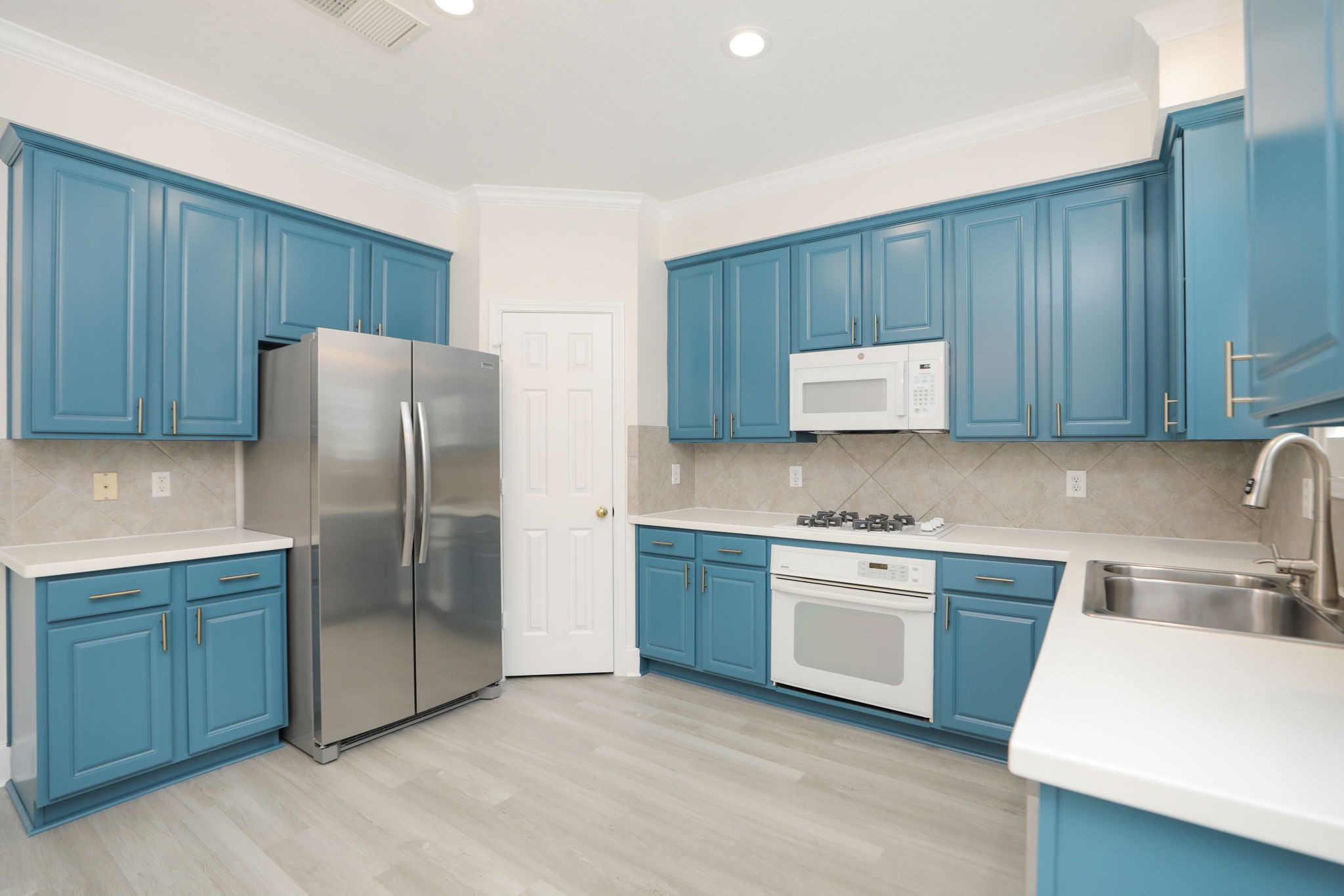 1893 Ewing Street Houston, TX 77004 - Photo 23 of 39 a kitchen with stainless steel appliances a refrigerator and a sink