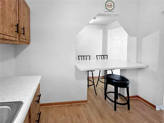 a view of a room with furniture and wooden floor