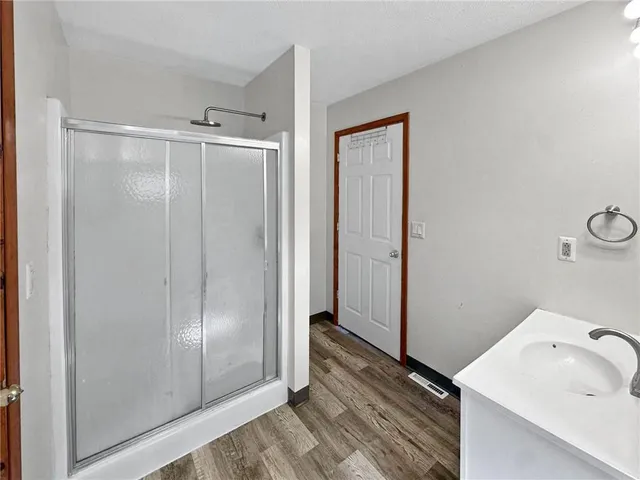a bathroom with a sink and shower