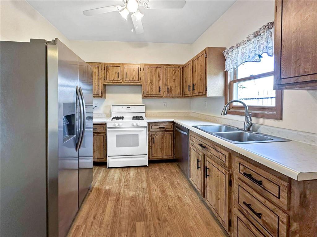 148 Oak Spring Road Canonsburg, PA 15317 - Photo 8 of 34 a kitchen with stainless steel appliances a sink cabinets and a wooden floor