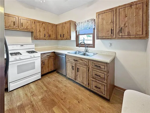 a kitchen with stainless steel appliances granite countertop a sink stove and cabinets