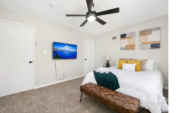 a living room with furniture and a ceiling fan