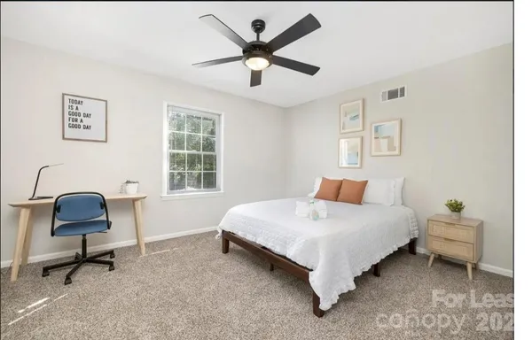 a bedroom with a bed chair and a window