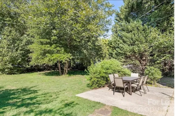 a view of a table and chairs in the garden