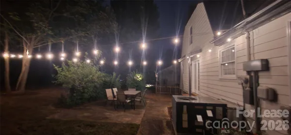 a view of a porch with furniture and a yard