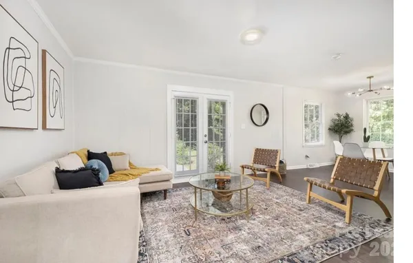 a living room with furniture a rug and a large window