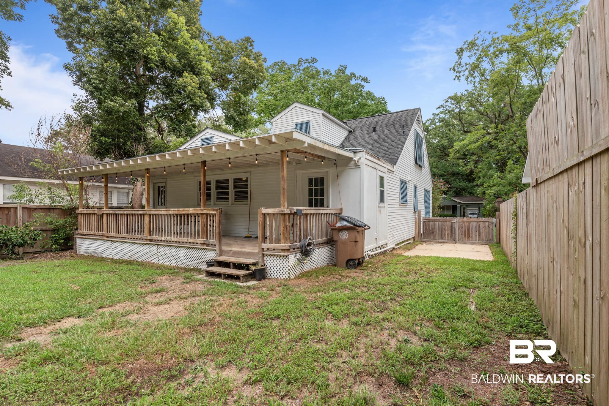 114 Crenshaw Street Mobile, AL 36606 - Photo 46 of 49 Rear view of property featuring a deck, a lawn, and a pergola