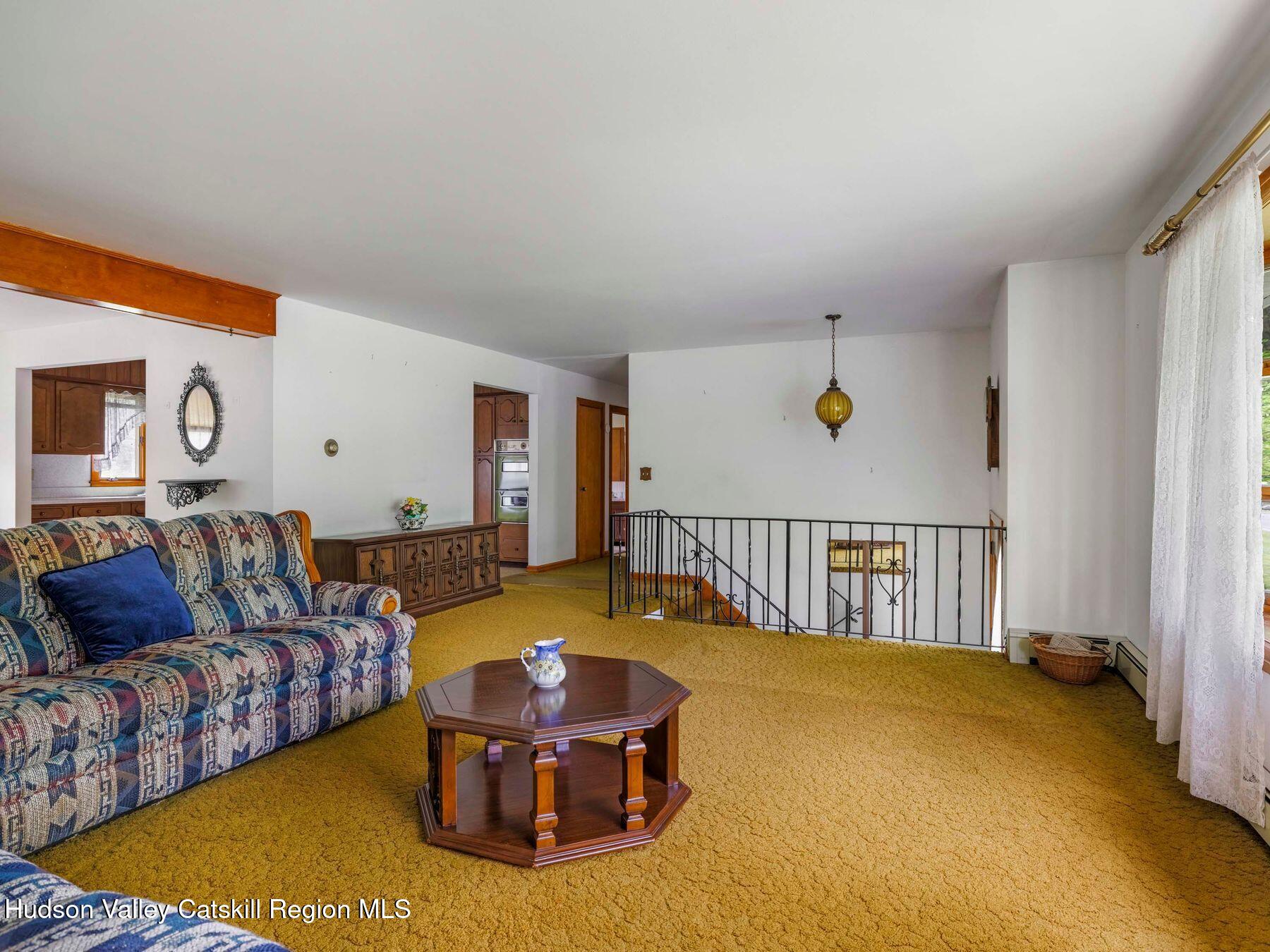 104 New Paltz Road Highland, NY 12528 - Photo 12 of 43 a living room with furniture and a table