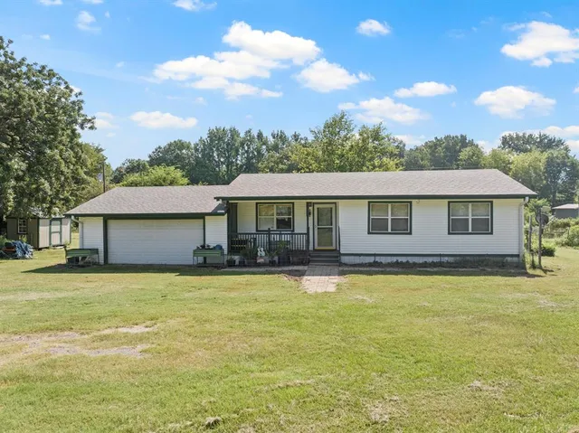 a view of a house with swimming pool having outdoor seating