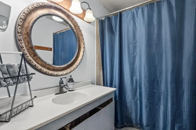 a bedroom with a bed chair and a window