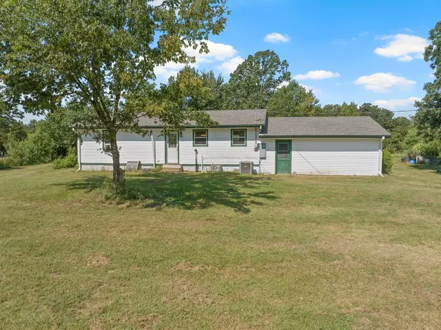 a view of a yard in front of a house with a garage