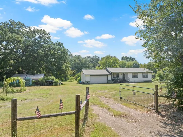a view of a backyard with chairs