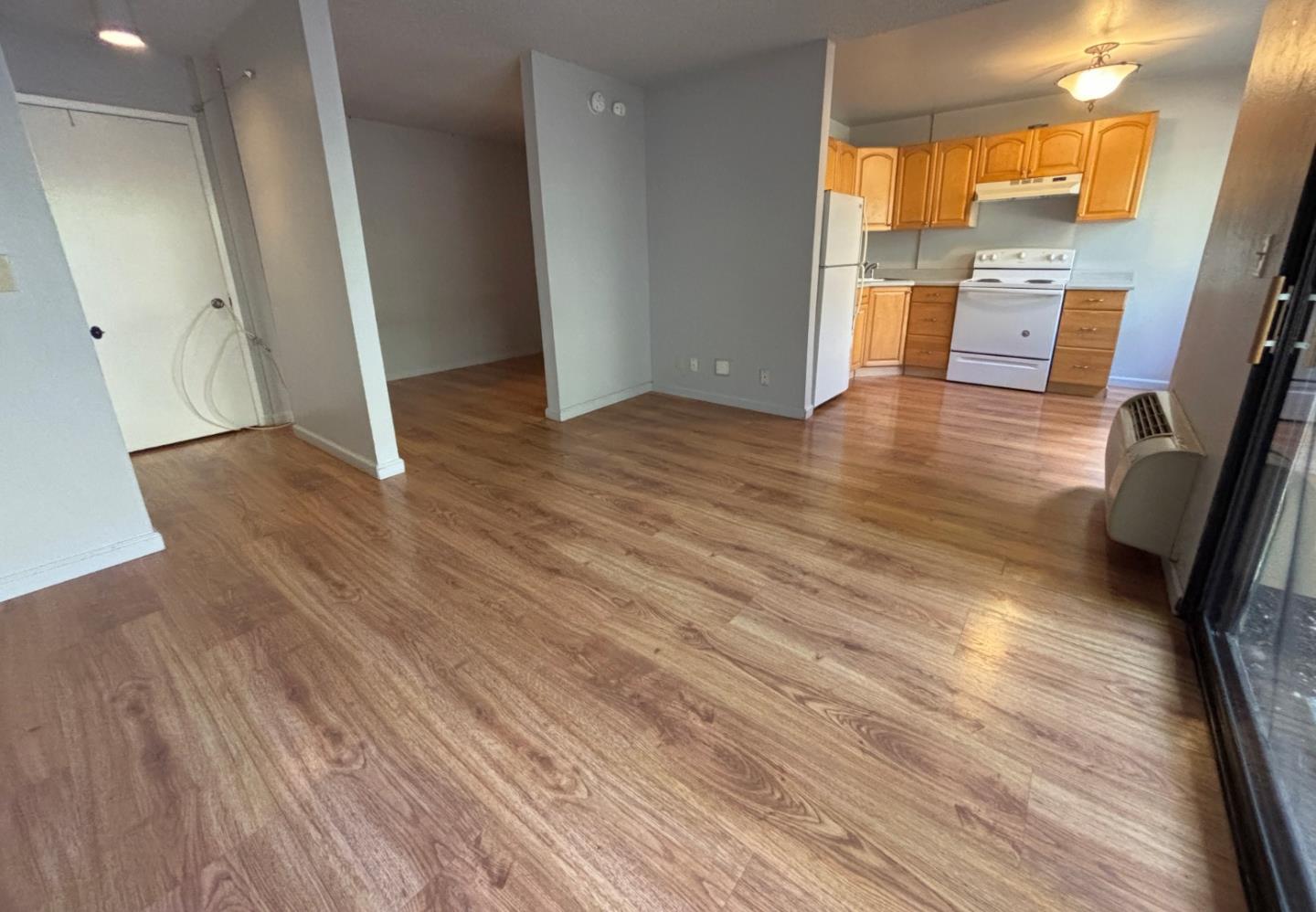 934 Kiely Boulevard, Unit B Santa Clara, CA 95051 - Photo 6 of 19 wooden floor in an empty room with a window