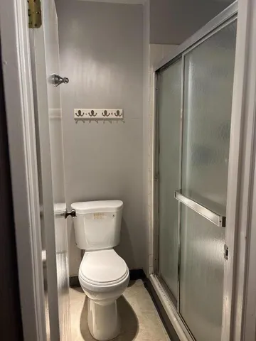 a bathroom with a toilet and a shower