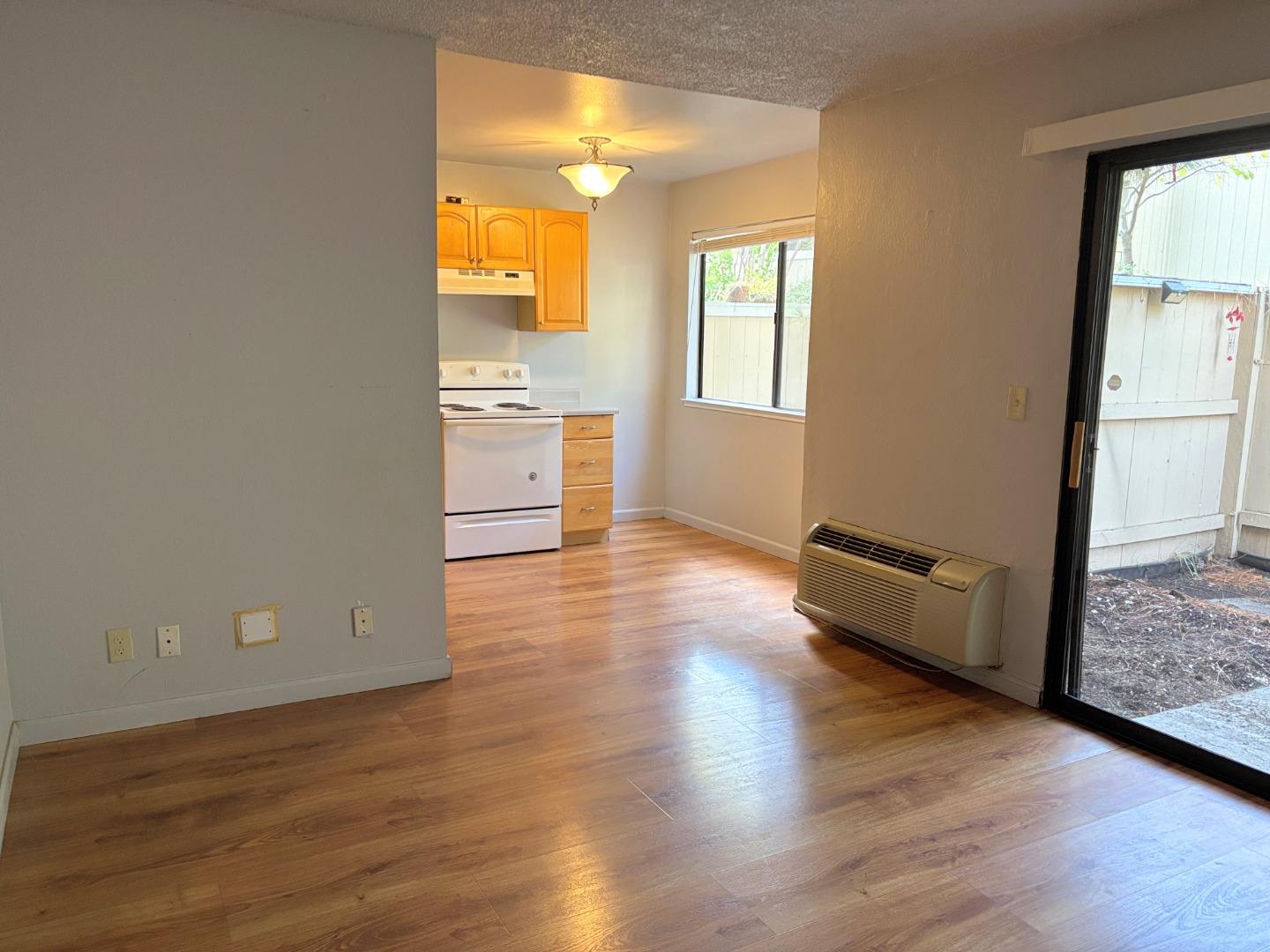 934 Kiely Boulevard, Unit B Santa Clara, CA 95051 - Photo 8 of 19 an empty room with wooden floor and windows