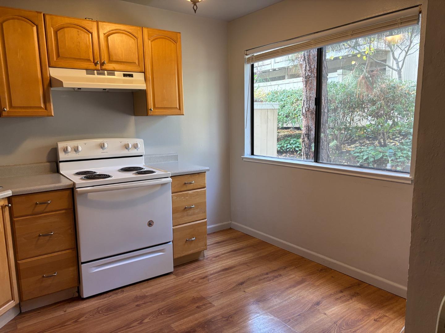 934 Kiely Boulevard, Unit B Santa Clara, CA 95051 - Photo 10 of 19 a utility room with wooden floor and a window
