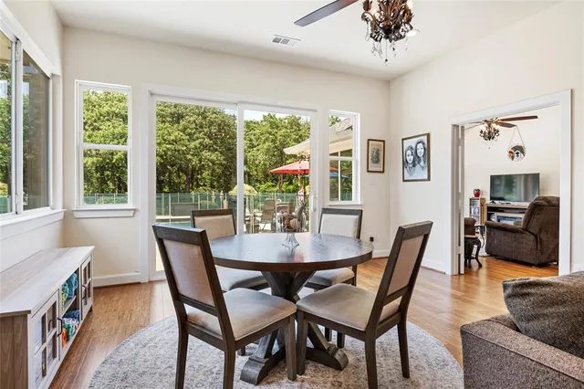 a view of a dining room with furniture window and wooden floor
