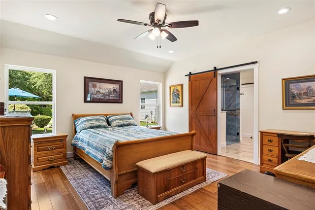 a bedroom with a bed couch and a window