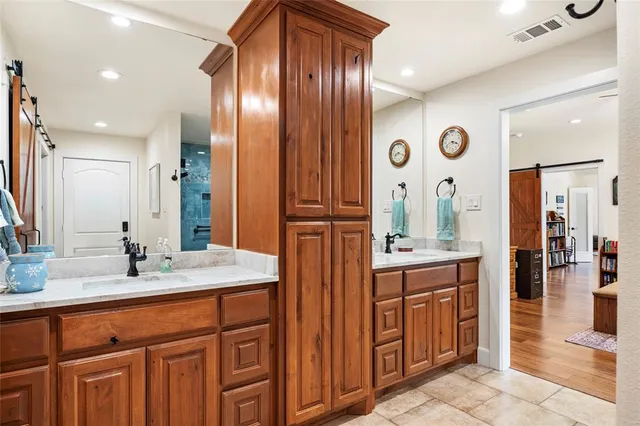 a bathroom with a sink double vanity and a mirror