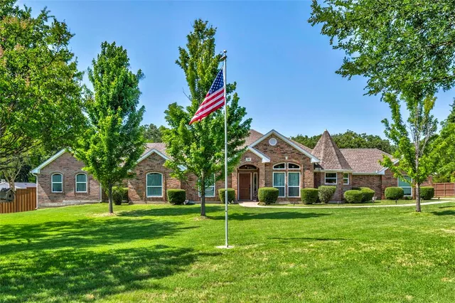 a house with green field in front of it