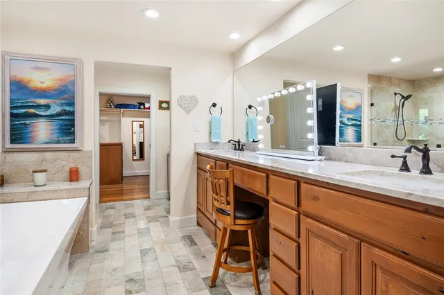 a spacious bathroom with a double vanity sink a mirror and a shower