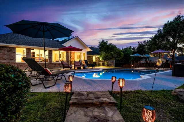 a view of a swimming pool with sitting area