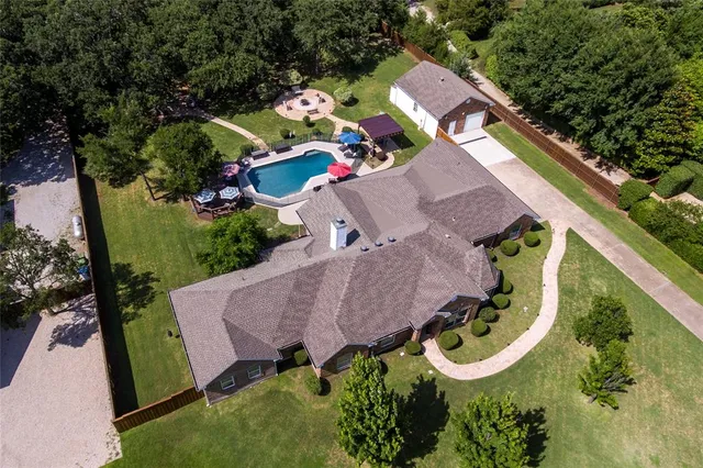 an aerial view of a house with a yard
