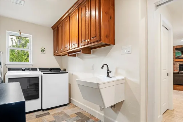 a kitchen with a sink cabinets and window