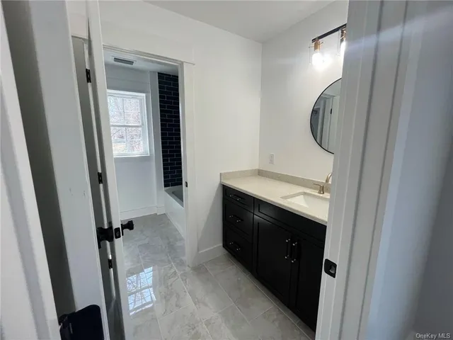 a bathroom with a mirror and a sink