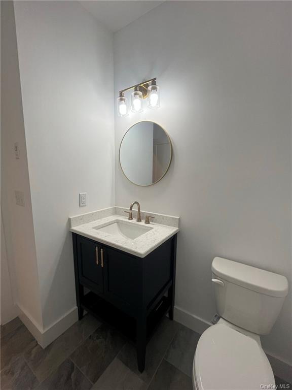 268 Lybolt Road Middletown, NY 10941 - Photo 27 of 28 a bathroom with a toilet a sink and mirror