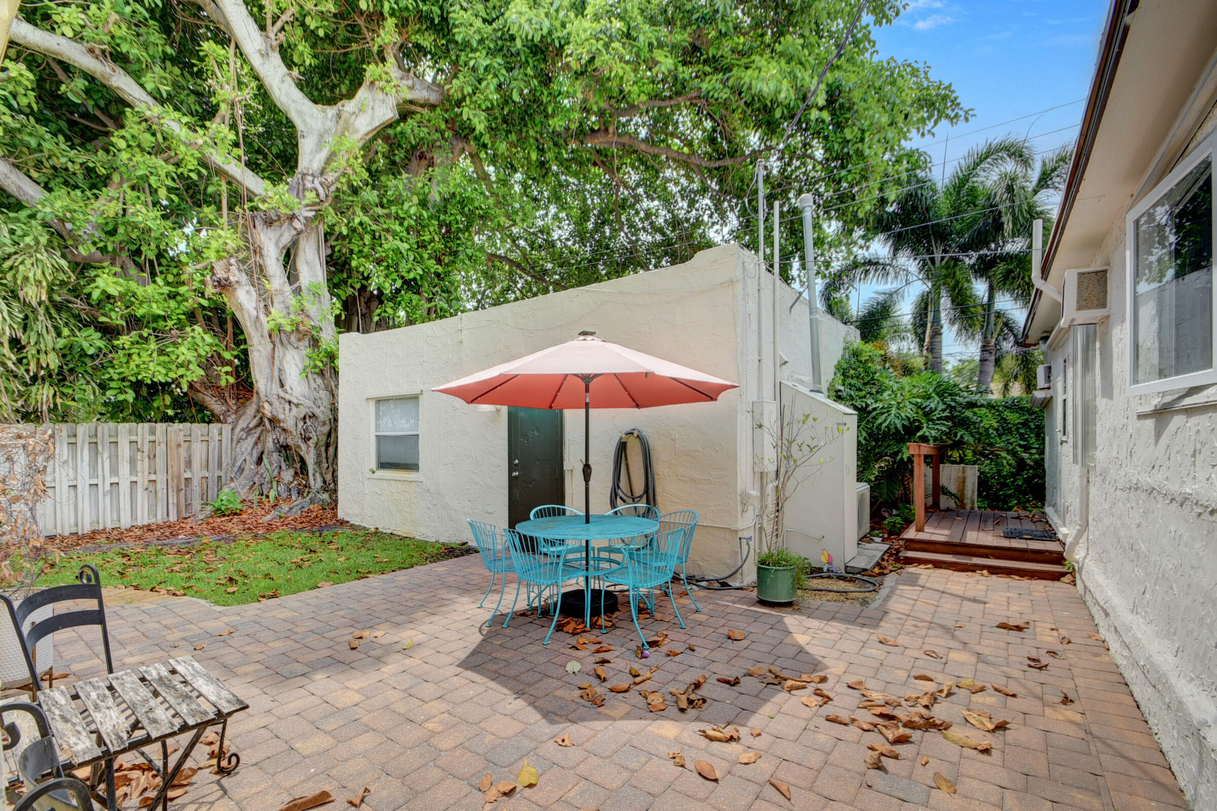 a wooden bench sitting in backyard of a house