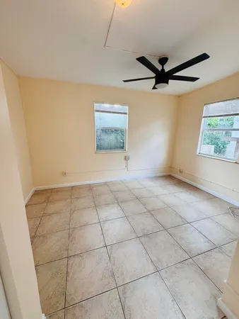 a view of a livingroom with a ceiling fan and window